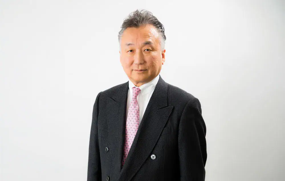 Businessman in formal suit posing for professional photo.