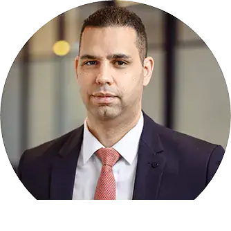 Business professional in formal suit and tie, corporate setting.